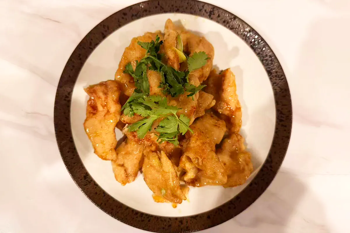 A classic dish from Northeast China. The battered pork slices are golden and glazed in a translucent, amber-colored Sweet and sour sauce, and served with carrots, scallion, ginger and cilantro at Chef Ma，a Chinese Restaurant in Edison